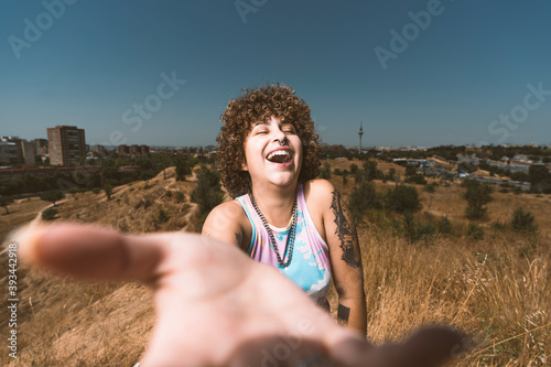 Smiling woman showing hand while standing against clear sky photo