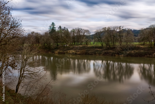 Umpqua river in Oregon.  Calm river landscape in an early spring overcast day