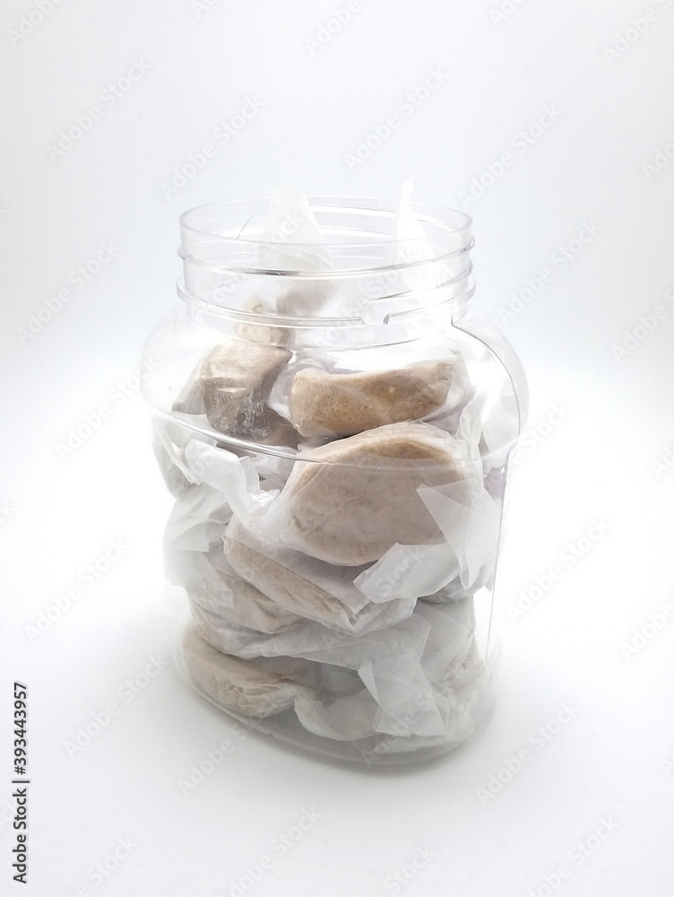 Polvoron shortbread with white wrapper packaging on plastic jar