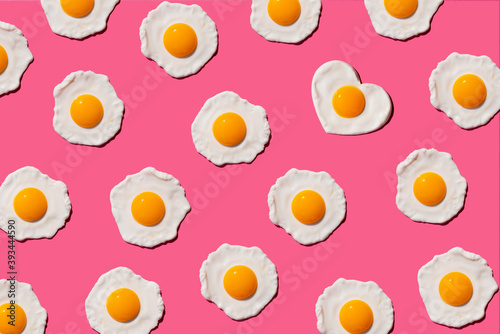 Pattern of fried eggs with single heart shaped one