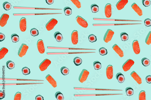 California roll and salman sushi nigiri with chopsticks on mint green background