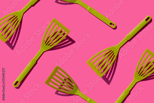 Pattern of green spatulas against pink background photo