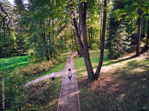 Woman walking on footpath in park photo