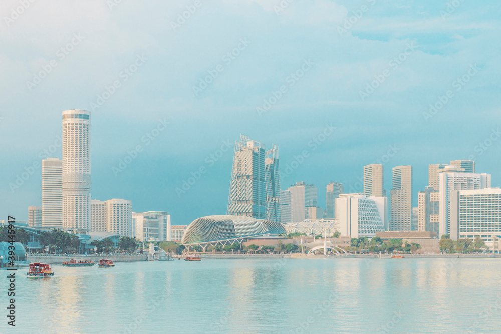 Marina Bay and Esplanade Theater in front of river against blue sky Marina Bay and Esplanade Theater in front of river against blue sky