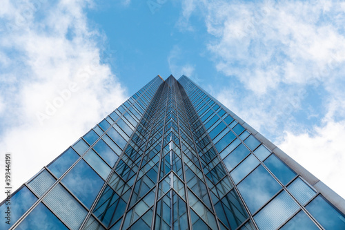 Tall modern office glass skyscraper against blue sky, London, UK