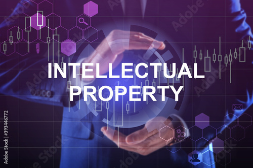 Intellectual property concept. Man using virtual screen with schemes, closeup