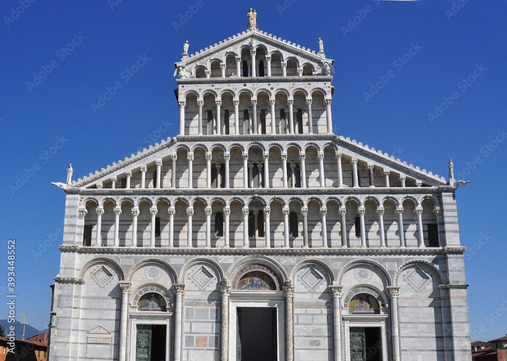 The ornate and strikingly beautiful facade of the Basilica at Pisa. The symmetry and detail are distinctive feature of  this edifice.