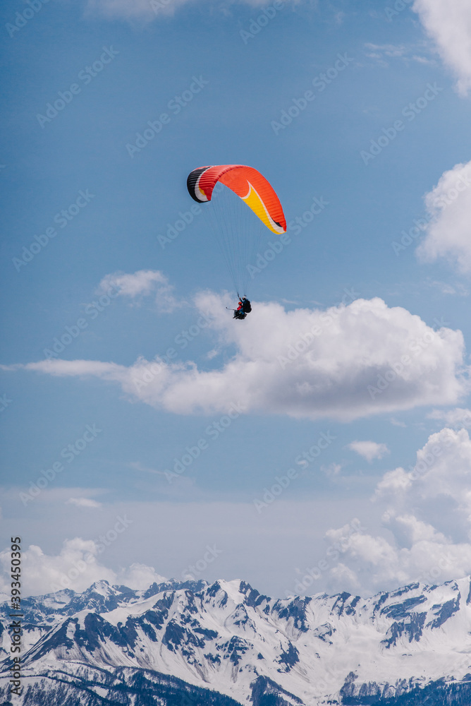 Paraglider flies over the mountains. Paraglider in the sky. Paraglider flies over the mountains. Paraglider in the sky.