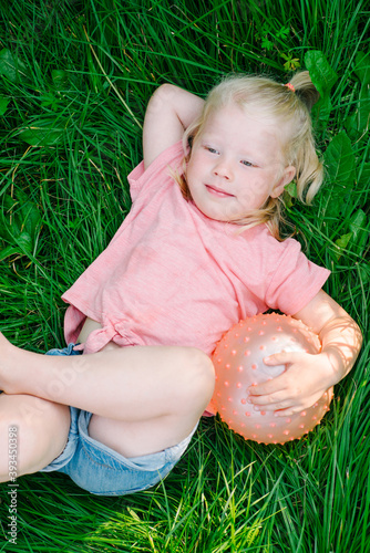 Blonde girl lying in the grass.