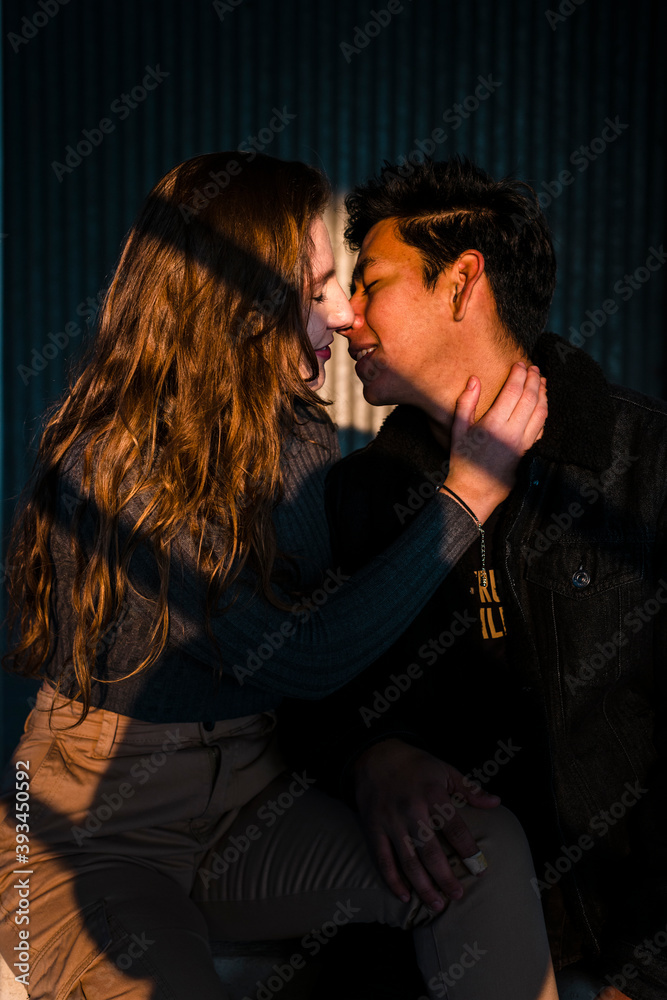 Ethnic trendy young man near face of attractive woman Ethnic trendy young man near face of attractive woman