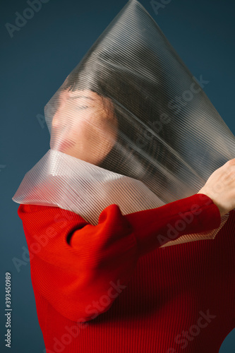 portrait of a woman holding a transparent plastic