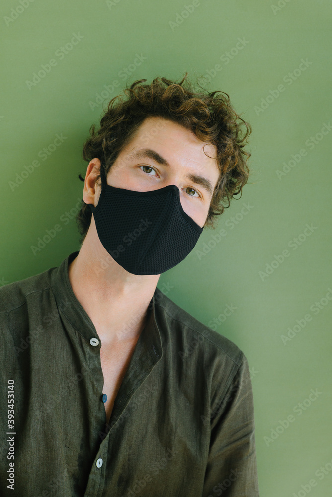 Curly man in a protective mask from textiles. Curly man in a protective mask from textiles.