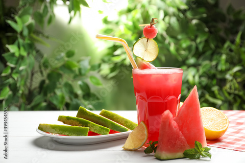 Delicious fresh watermelon drink on white wooden table photo