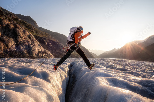 brave woman jumping over crevasse photo
