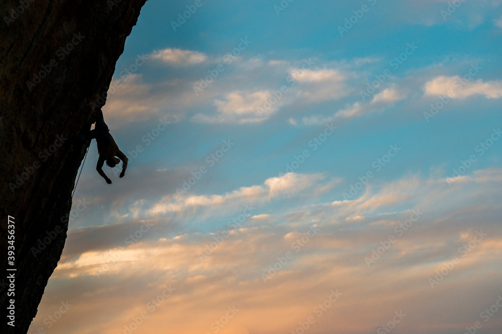 Faceless alpinist climbing up on cliff in Spain Faceless alpinist climbing up on cliff in Spain