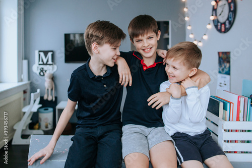 Three young brothers in a children's playroom. photo