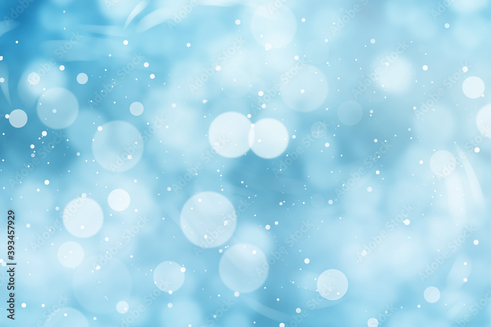 Abstract snowfall on light blue background, bokeh effect