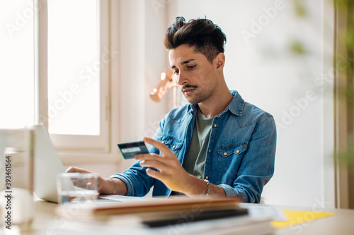 Young man transferring money online