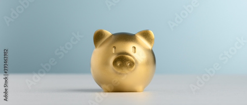 Golden Piggy Bank with blue background for saving and invest concept.