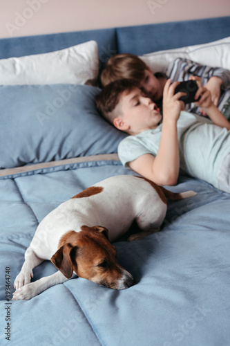 Young brothers use an electronic gadget. photo