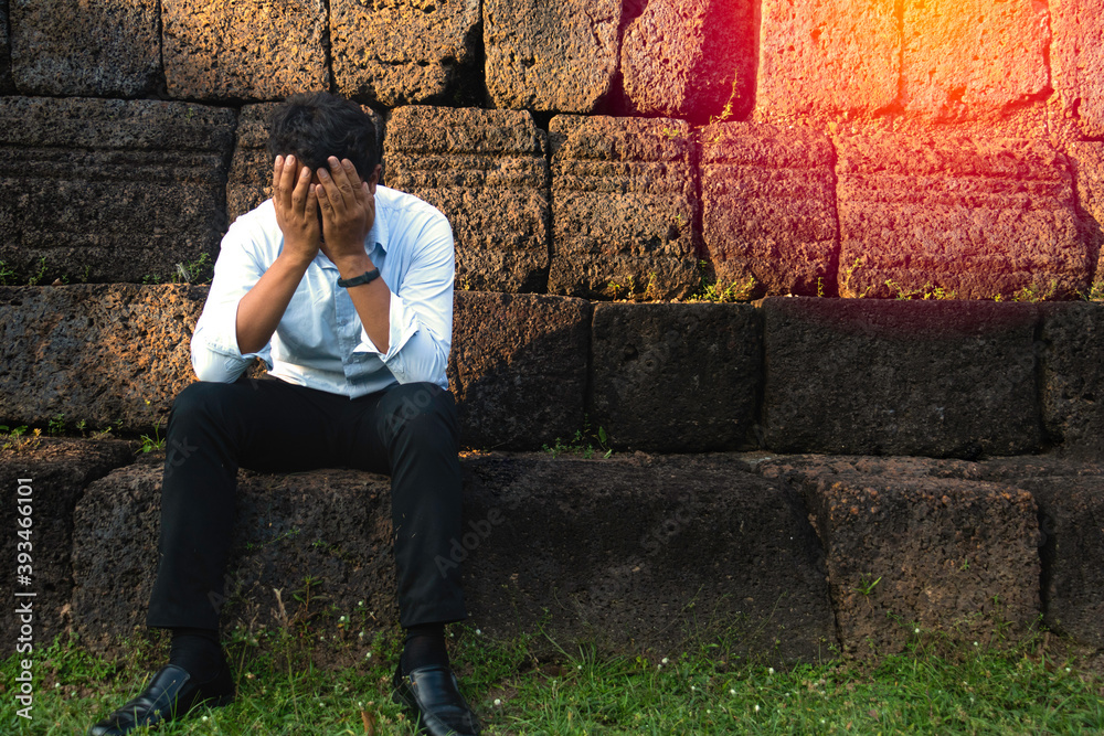 Asia you man sitting alone.He sitting alone beside old wall.man very sad and depressed.sad,alone,suicide,despair,sickness,photo health and disappointment concept. Asia you man sitting alone.He sitting alone beside old wall.man very sad and depressed.sad,alone,suicide,despair,sickness,photo health and disappointment concept.