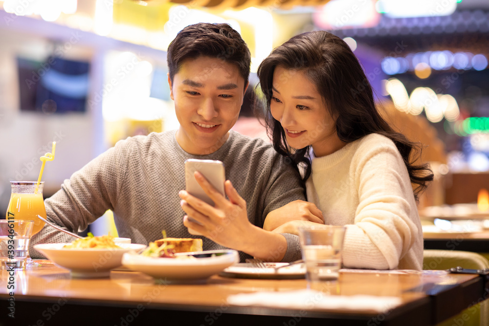 Happy young couple dating in restaurant Happy young couple dating in restaurant