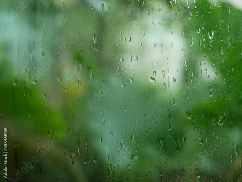 rain water drops on the window glass in rainy day.