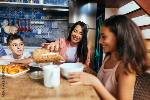 Latin family eating healthy breakfast in the kitchen