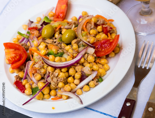 Empedrado garbanzos, traditional spanish salad with chickpeas, crumbled cod, olives, tomato, onion and bell pepper