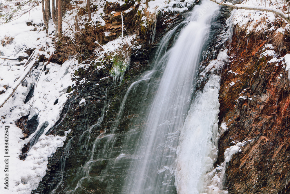 Obraz premium Natural water cascade in winter . Frost waterfall scenery 