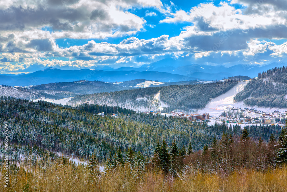 Ski resort in the mountains . Winter landscape with forest and mountains