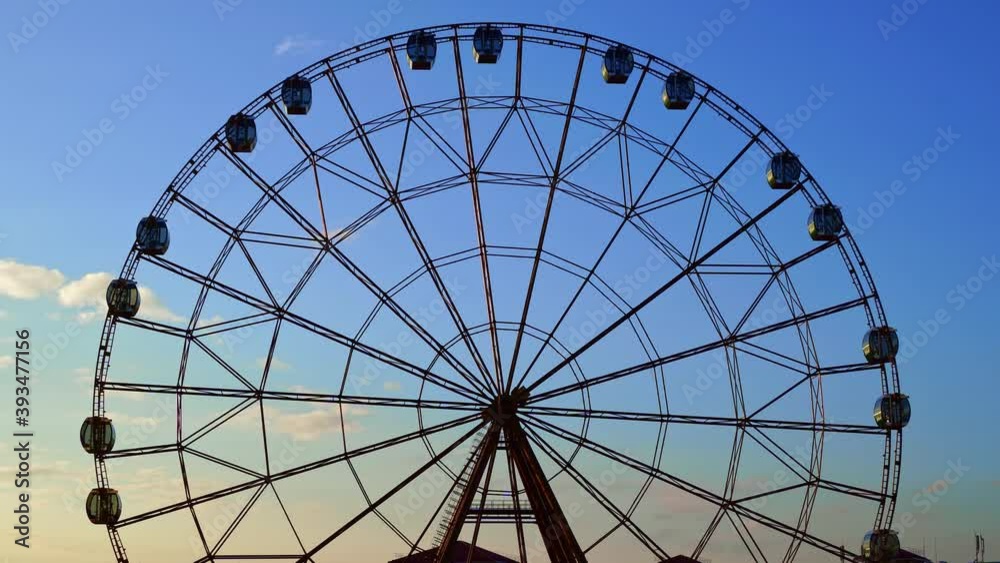accelerated. Ferris wheel against a blue sky. accelerated. Ferris wheel against a blue sky.