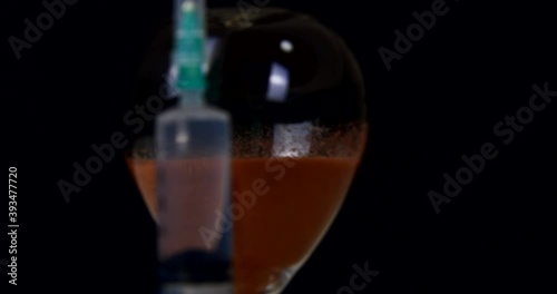 syringe with injection and face mask and hourglass