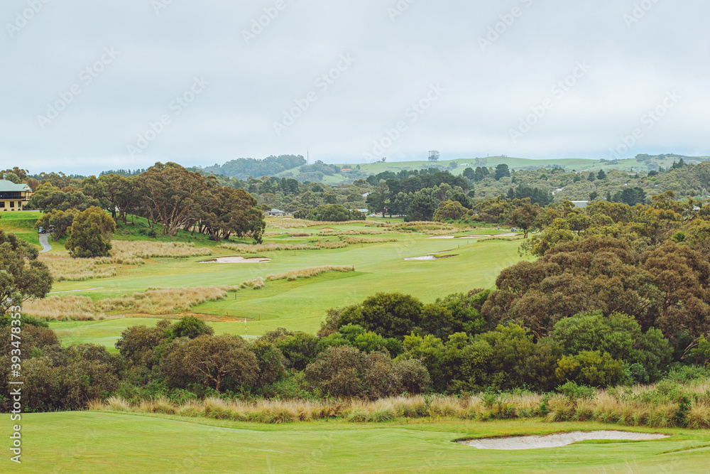 landscape of golf course with cloudy sky 