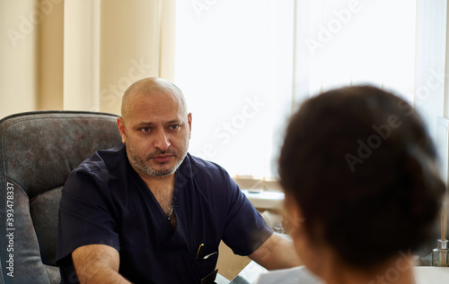 The doctor's consultation. Portrait of a doctor in uniform leading a consultation.