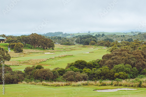 landscape of golf course with cloudy sky 