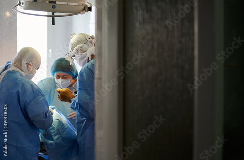 Surgery. The operation is in progress. View from behind the operating room door.