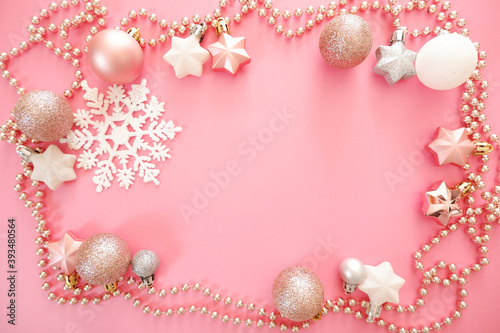 Christmas background with snowflakes and pink ornaments. winter holiday and new year concept.