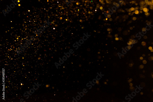 Abstract gold bokeh with black background
