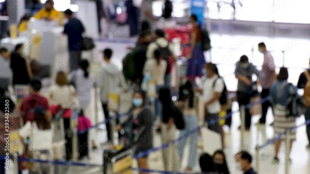 Blurred and unrecognizable Asian people waiting to check in at the airport. everyone wearing disposal face mask for protect coronavirus. airport open after covid-19 epidemic Blurred and unrecognizable Asian people waiting to check in at the airport. everyone wearing disposal face mask for protect coronavirus. airport open after covid-19 epidemic