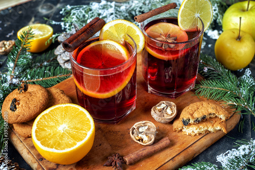 Christmas hot mulled wine in a glass with spices and citrus fruits .