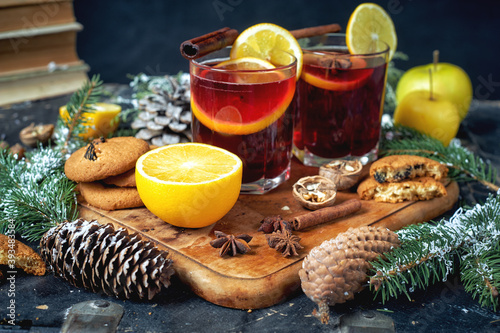 Christmas hot mulled wine in a glass with spices and citrus fruits .