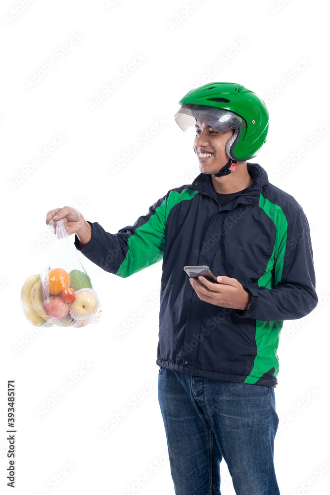 grocery delivery. courier wearing helmet and jacket uniform holding food isolated over white background grocery delivery. courier wearing helmet and jacket uniform holding food isolated over white background