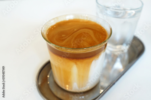 Close up glass of Latte coffee with iced water