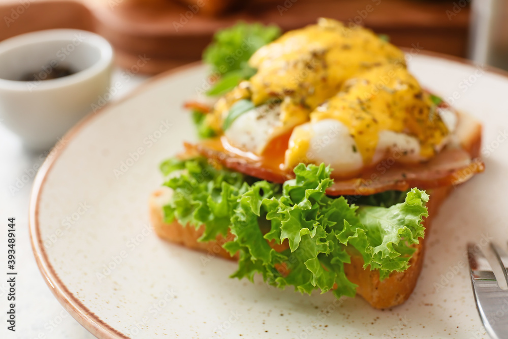 Plate with tasty egg Benedict on table, closeup