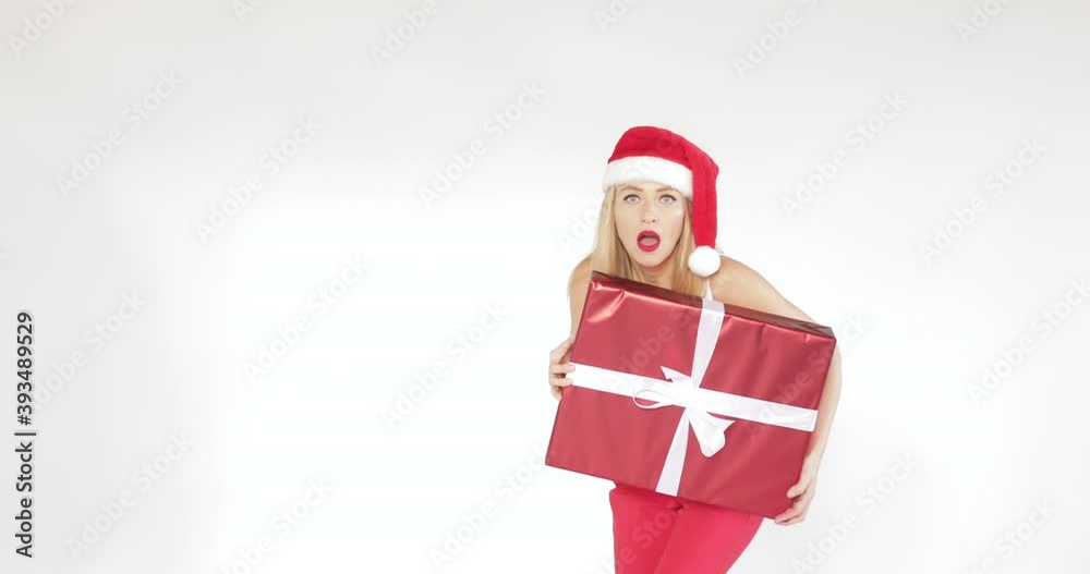 Pretty young lady sneaking with gift box while while scared and missing the box, isolated on white background. Christmas holiday concept Pretty young lady sneaking with gift box while while scared and missing the box, isolated on white background. Christmas holiday concept