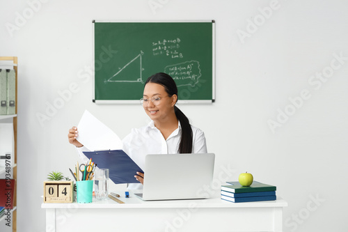 Asian female teacher sittin...