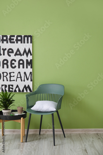 Fototapeta Naklejka Na Ścianę i Meble -  Chair and table near color wall in room