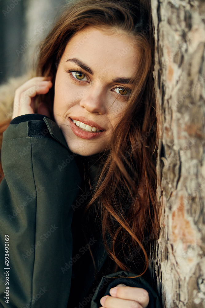 attractive woman leaning on a tree close-up attractive woman leaning on a tree close-up