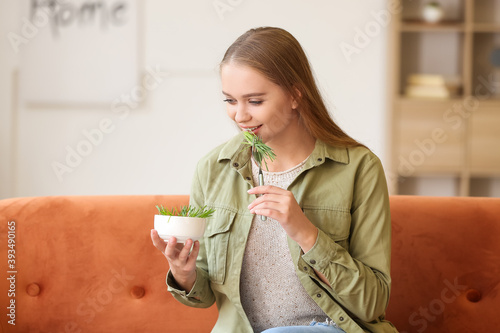 Young woman eating wheatgra...